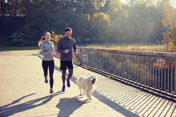 couple jogging with dog